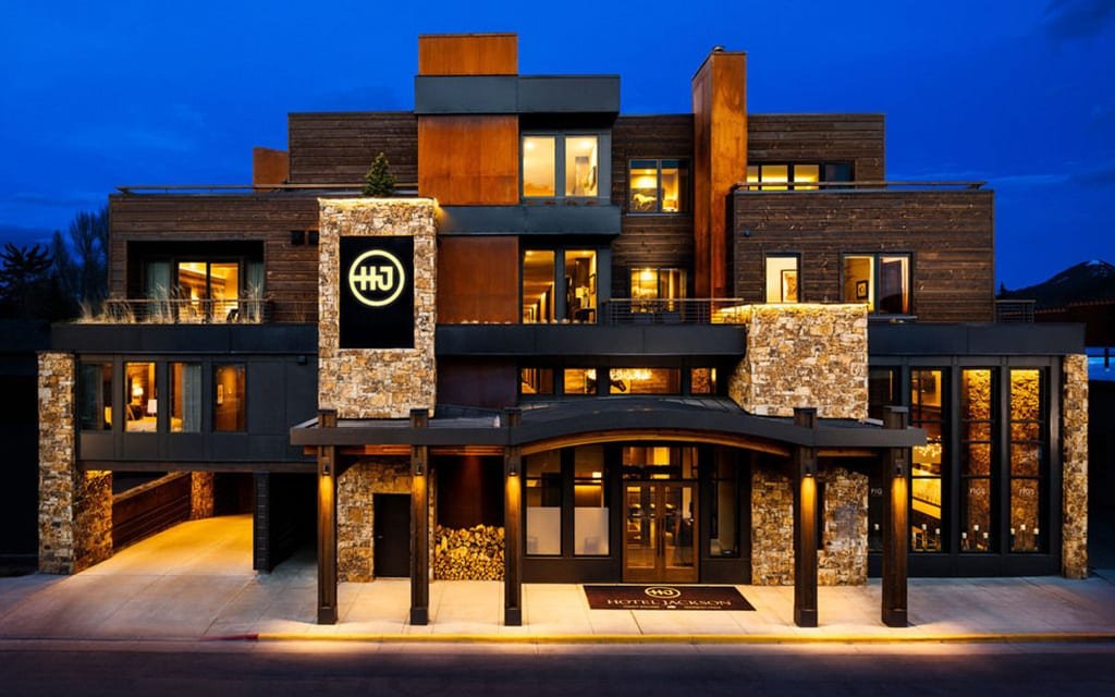 Modern boutique hotel exterior under a deep blue sky