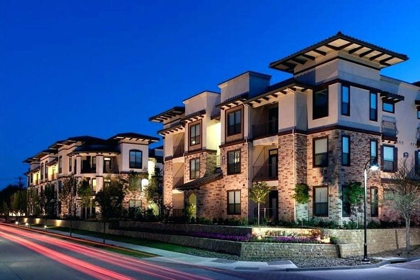 Luxury multifamily residences lit at dusk